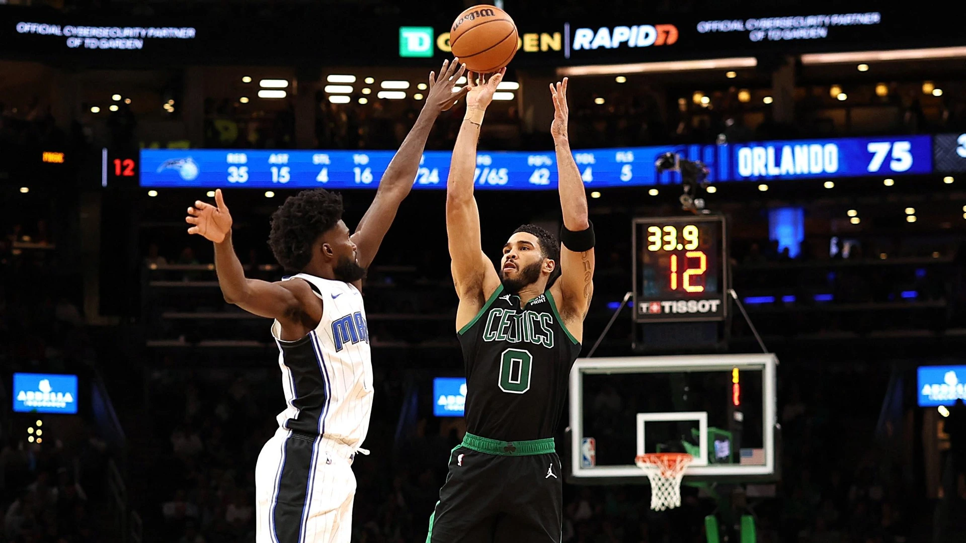 BOSTON, MASSACHUSETTS - DECEMBER 15: Jayson Tatum #0 of the Boston Celtics takes a shot against Jonathan Isaac #1 of the Orlando Magic December 15, 2023 in Boston, Massachusetts. The Celtics defeat the Magic 128-111.