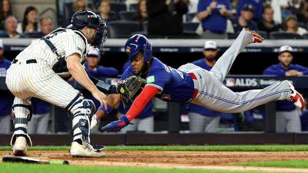 Vladimir Guerrero Jr. #27 of the Toronto Blue Jays slides safely into home plate to score against Austin Wells #28 of the New York Yankees during the third inning in game 3of the American League Division Series at Yankee Stadium on October 07, 2025