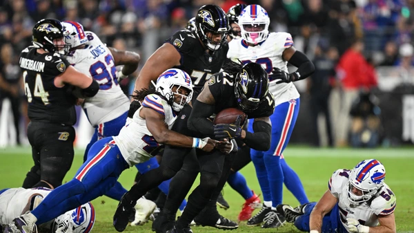BALTIMORE, MARYLAND - SEPTEMBER 29: Derrick Henry #22 of the Baltimore Ravens is tackled by Dorian Williams #42 of the Buffalo Bills during the fourth quarter at M&T Bank Stadium on September 29, 2024 in Baltimore, Maryland.