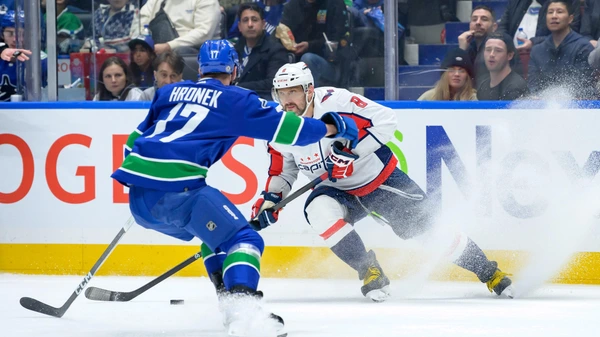 Filip Hronek #17 of the Vancouver Canucks defends against Alex Ovechkin #8 of the Washington Capitals during the third period of their NHL game at Rogers Arena on March 16, 2024 in Vancouver, British Columbia, Canada.