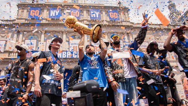 New York Knicks center Karl Anthony Towns holds the Larry O Brien Trophy alongside teammates Jose Alvarado and Tyler Kolek during the 2026 NBA Championship parade and celebration at City Hall Plaza in New York City, on June 18, 2026.