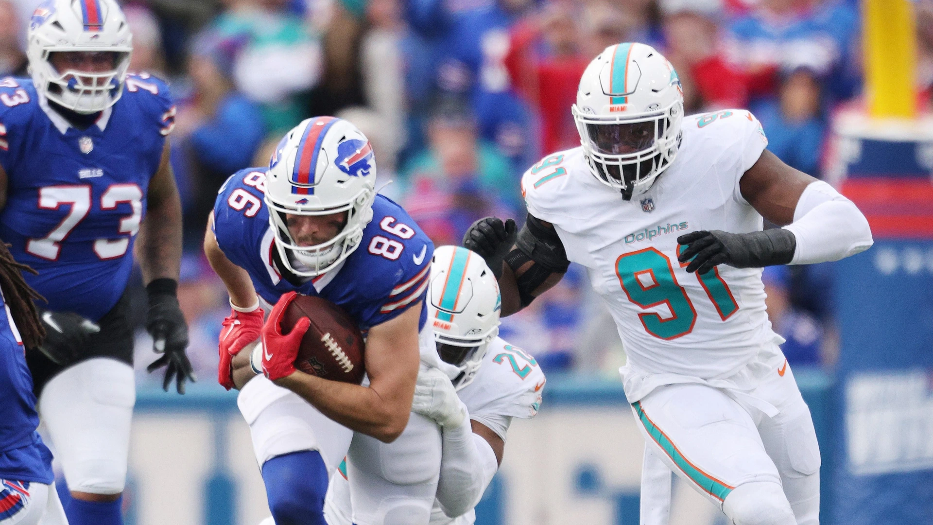 Jordyn Brooks #20 of the Miami Dolphins tackles Dalton Kincaid #86 of the Buffalo Bills during the third quarter at Highmark Stadium on November 03, 2024 in Orchard Park, New York.