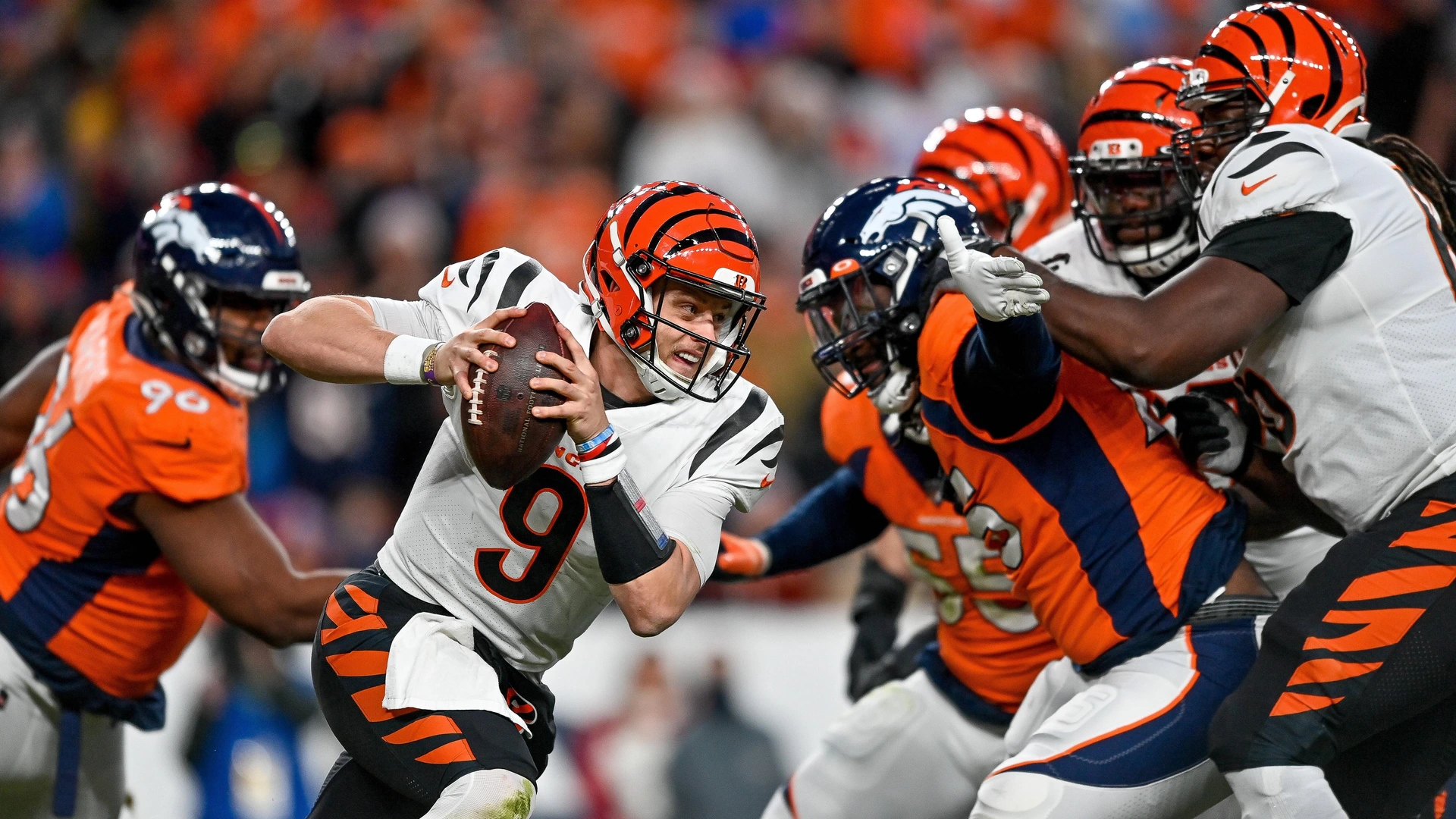 Cincinnati Bengals quarterback Joe Burrow 9 scrambles during a game between the Denver Broncos and the Cincinnati Bengals at Empower Field at Mile High on December 19, 2021 in Denver, Colorado. P